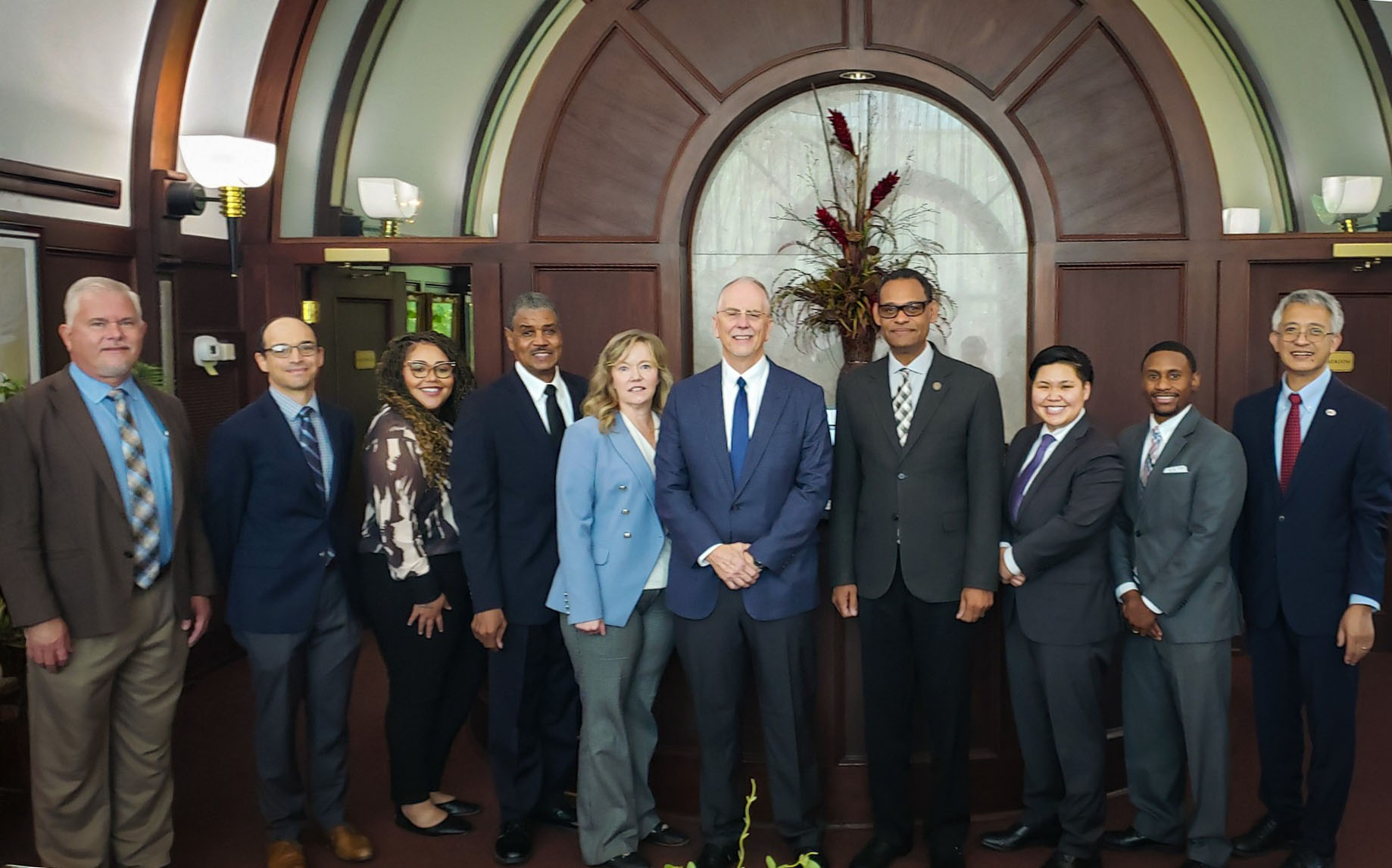 President Wims poses in his office with AAMU faculty and leaders from Sandia National Laboratories