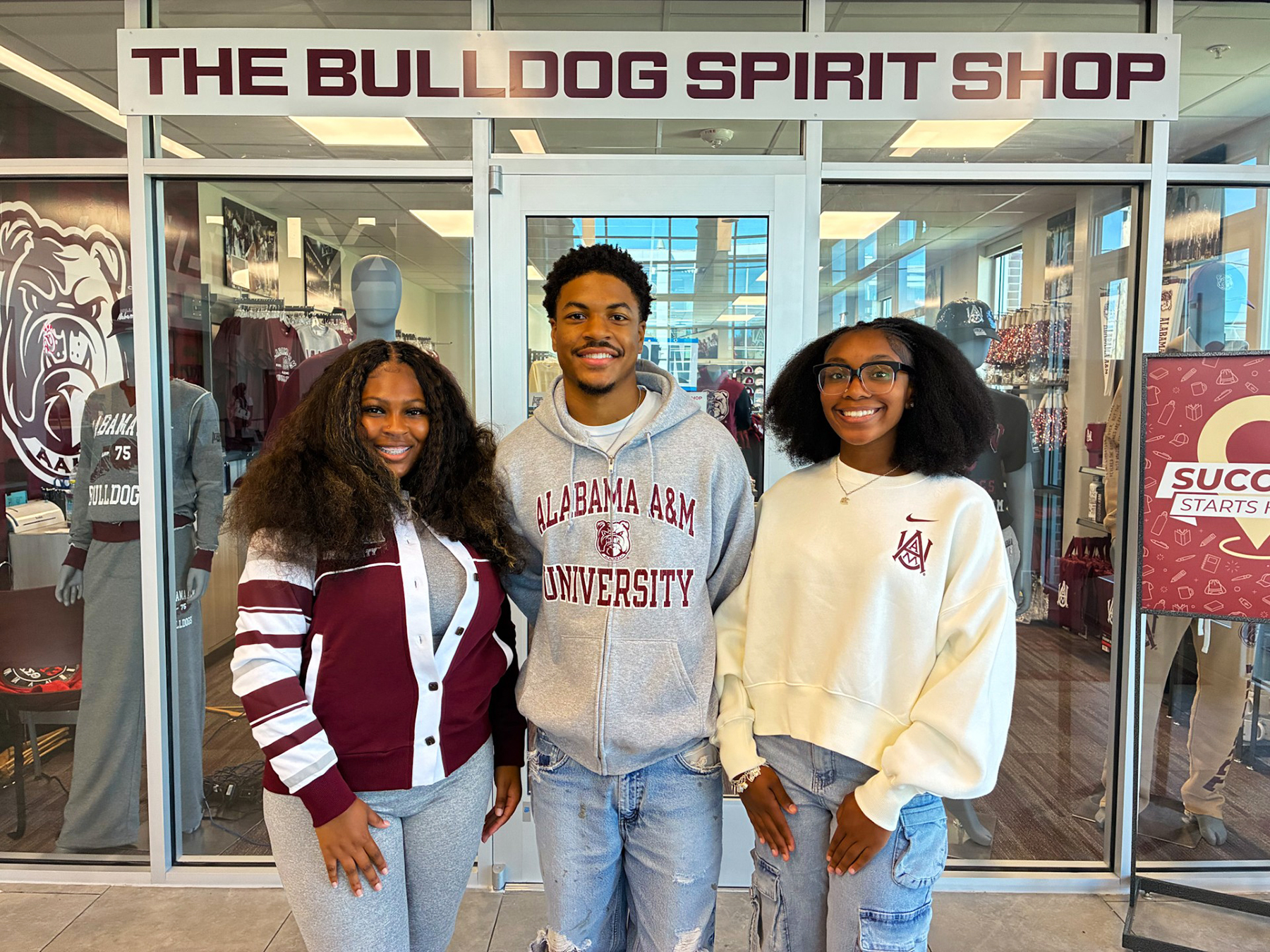 Alabama A&M University seniors Amiya Henderson, left, Dakota Hughley and A’Maya Jackson stand outside the new Bulldog Spirit Shop in the Welcome Center.