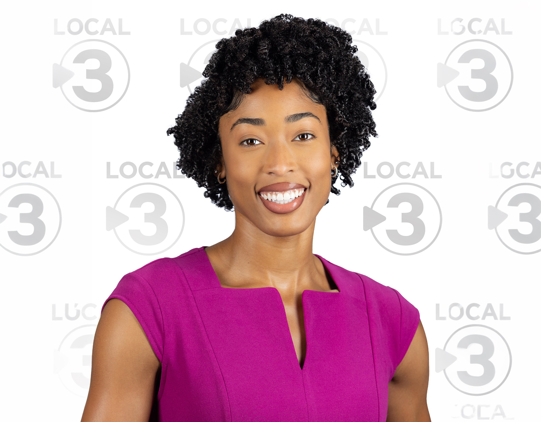 Madison Sims Smiles with station logo behind her