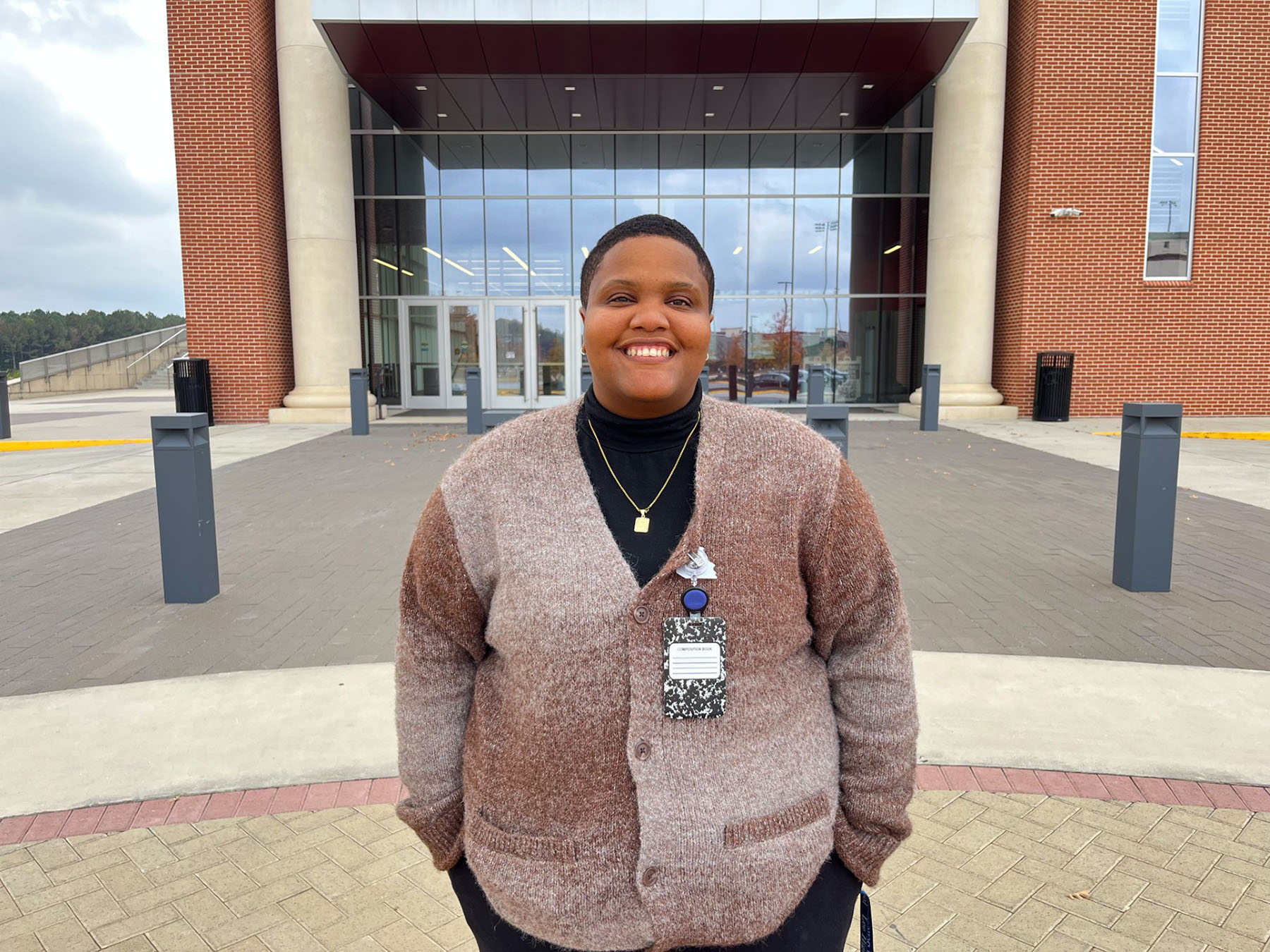 Daija Smoot smiles while standing in front of the AAMU Event Center