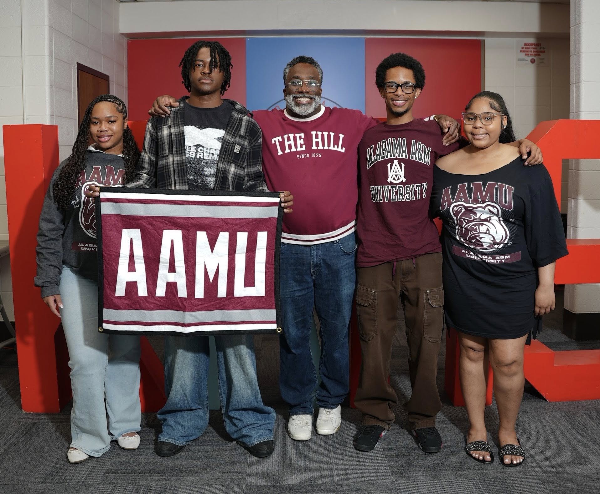 Londyn Alexander, Jaylen Island, Oliver Speller, Lester Barrett and Kyla Moore smile at the camera in the King Room at Kenwood Academy in Chicago
