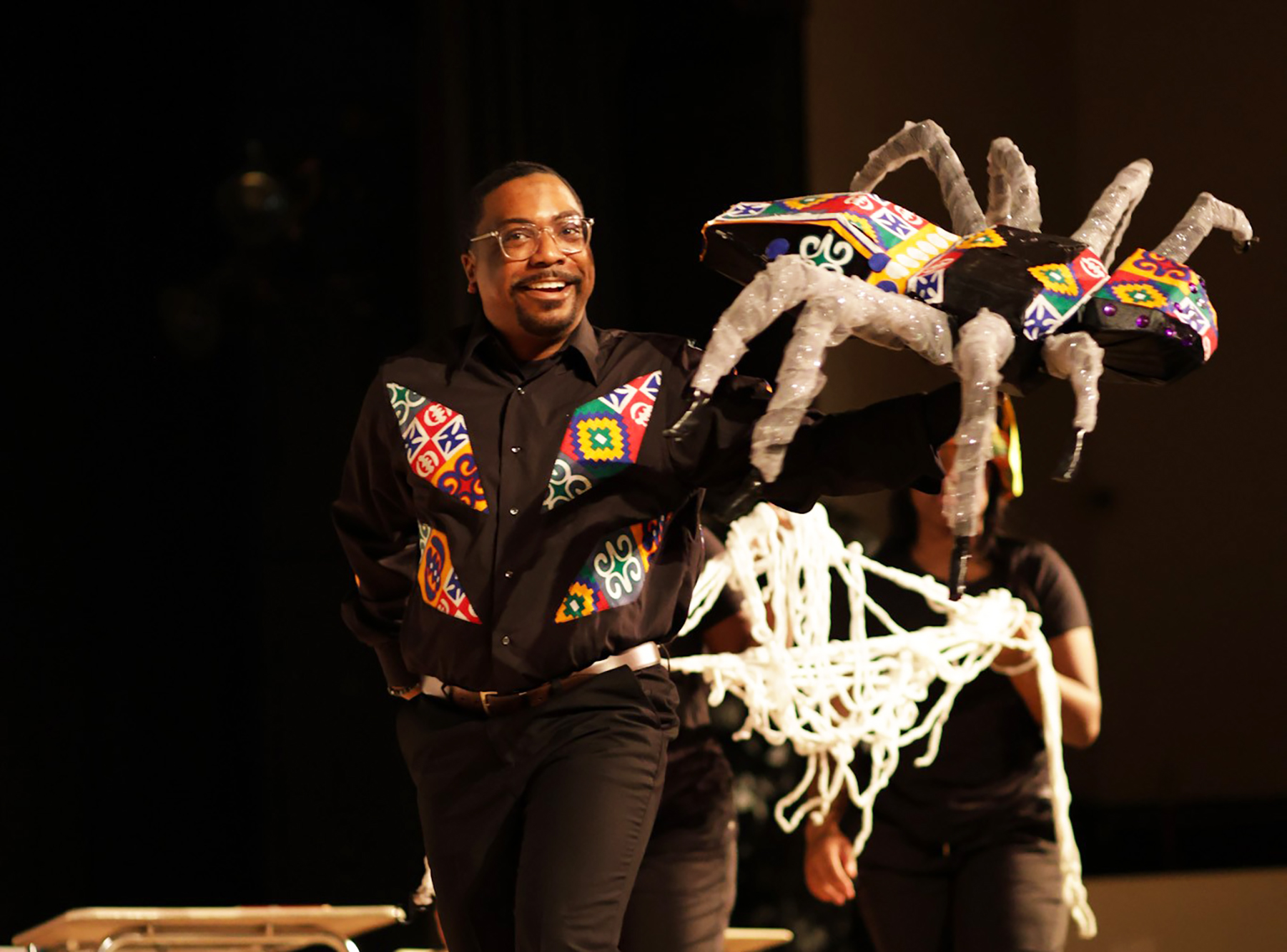 AAMU student on stage with Anansi the Spider  puppet