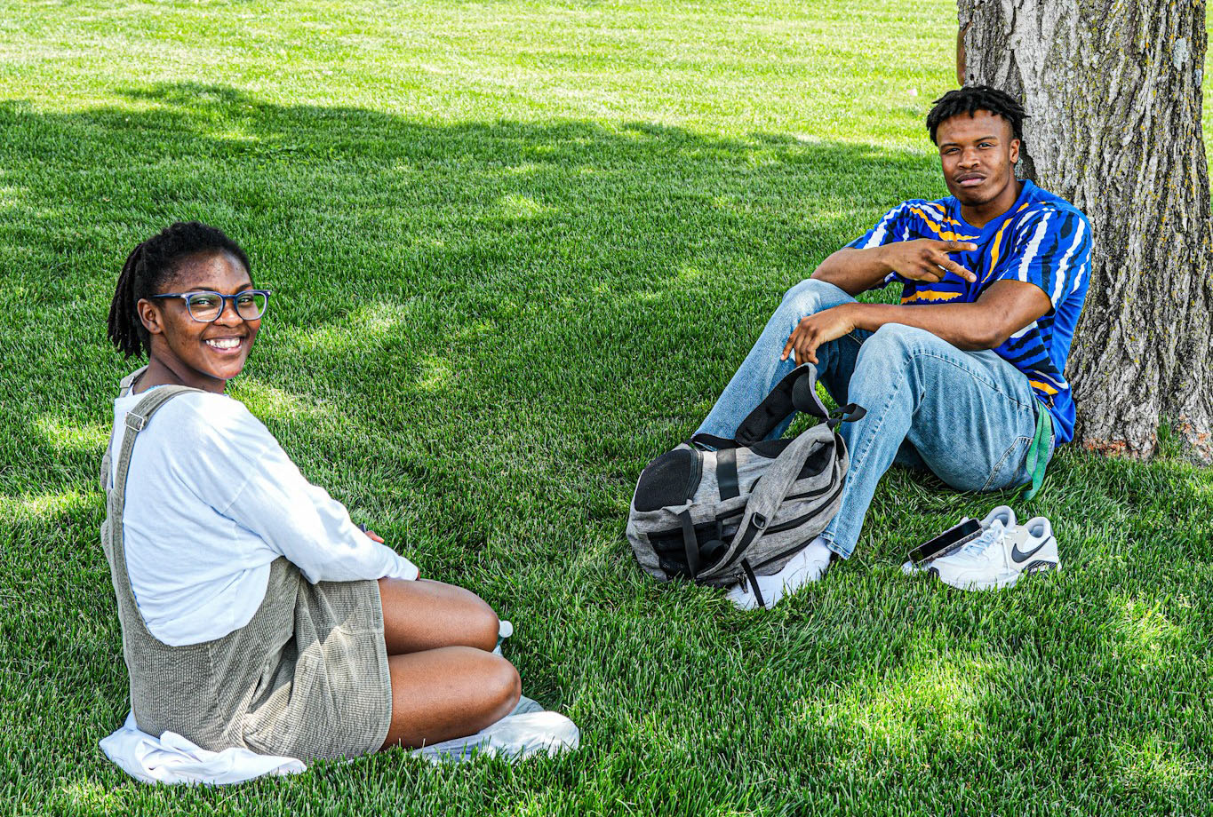 Two students sitting in the grass on The Quad at Alabama A&M University