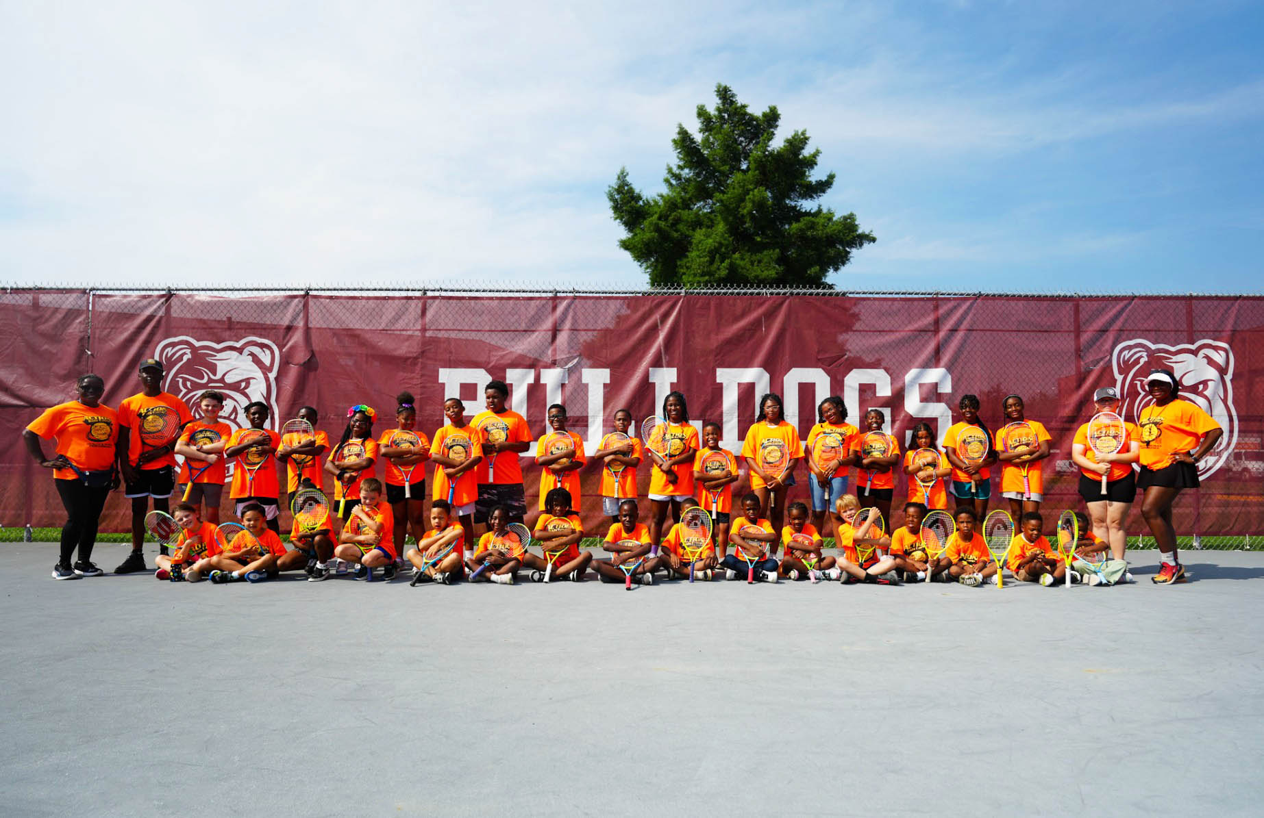 Dr. M-mbaha-Zarnesky in group photo of students and volunteers at AAMU Tennis Courts