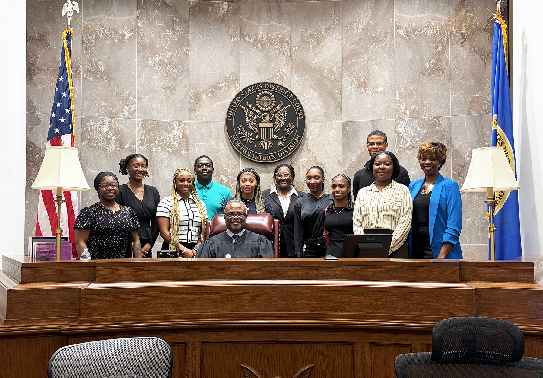 Students gather for a photo with U.S. Magistrate Judge John H. England III and Sonya Merritt, director of the Experiential Learning Opportunities Program, following a mock trial at the federal courthouse in Huntsville.