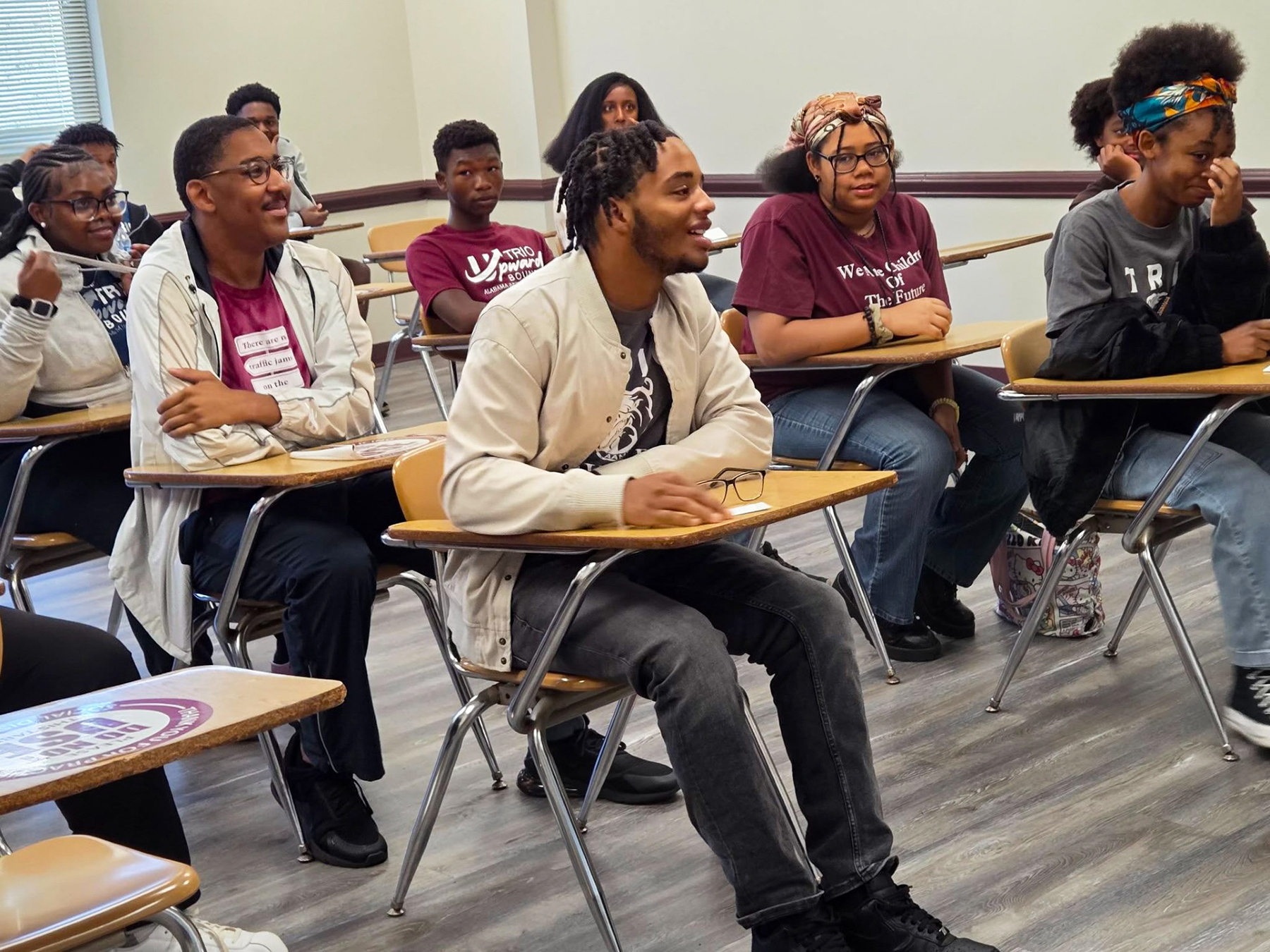 TRIO Upward Bound students seated in a classroom engaging in a discussion