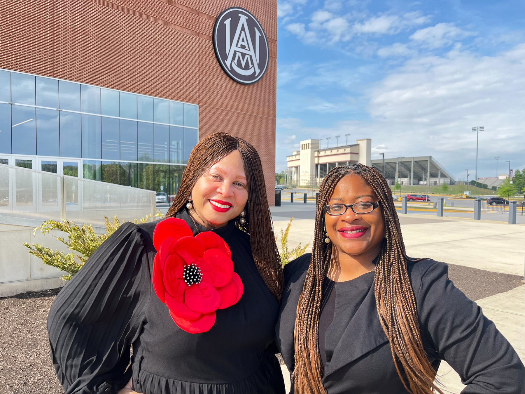 Charly Woodruff and Dr. Tennille Brownrigg smile outside the AAMU Event Center