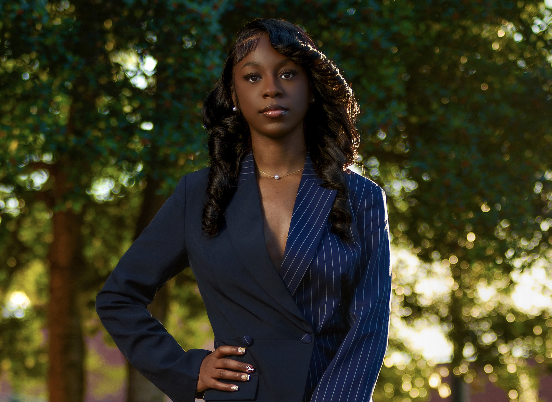 Yeniia Dixon on the AAMU campus with trees in the background
