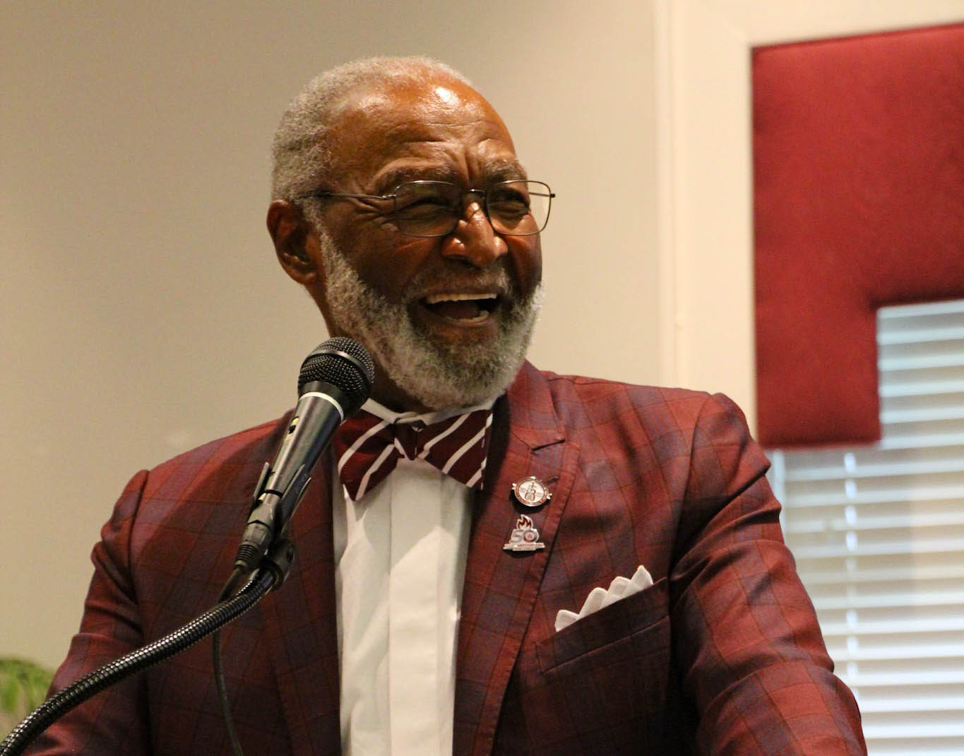 Mr. Robert Holmes speaks from podium at 2025 YMTF