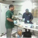 Two students with gloves work with chemicals