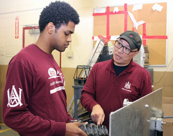 AAMU diverse faculty working with student