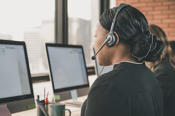 Student at computer on helpdesk phone