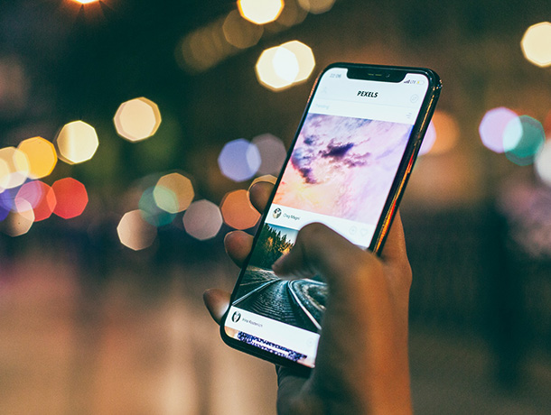 stock image of person holding iPhone at night