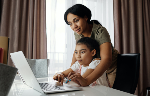 Student in-front of computer with parent