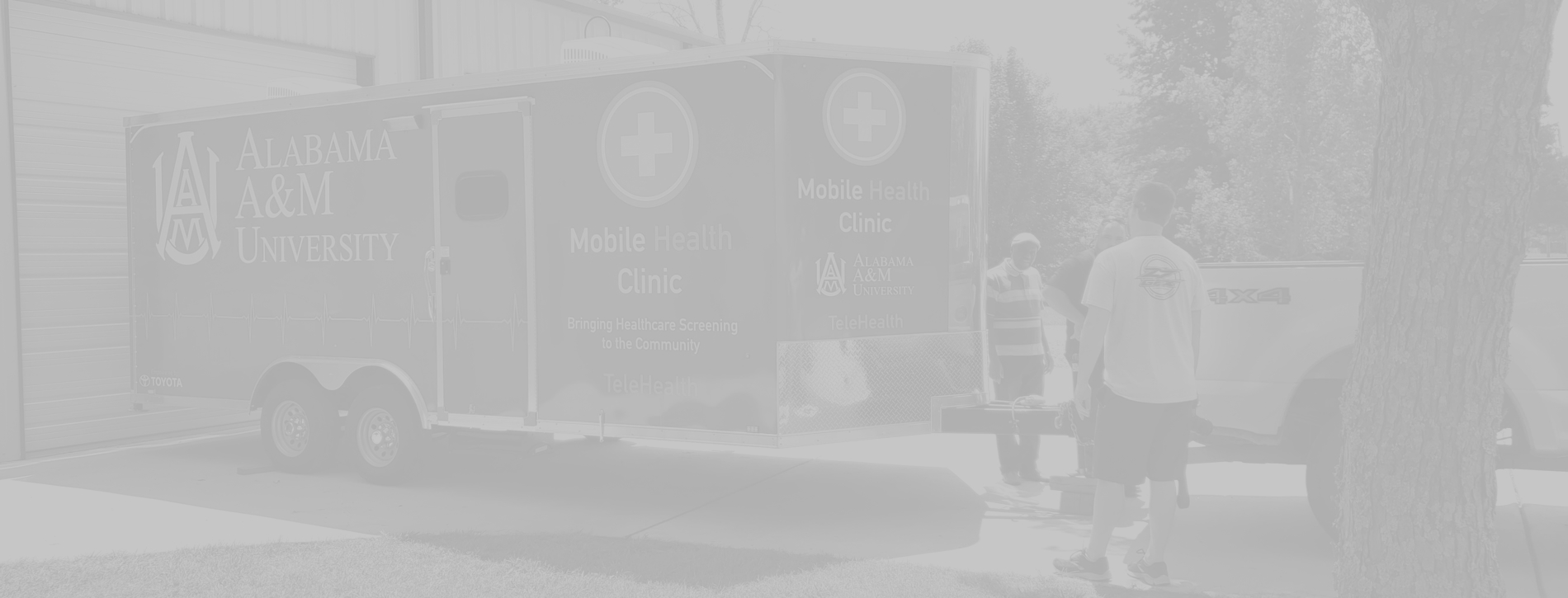 AAMU Mobbile Health Clinic trailer with truck and people