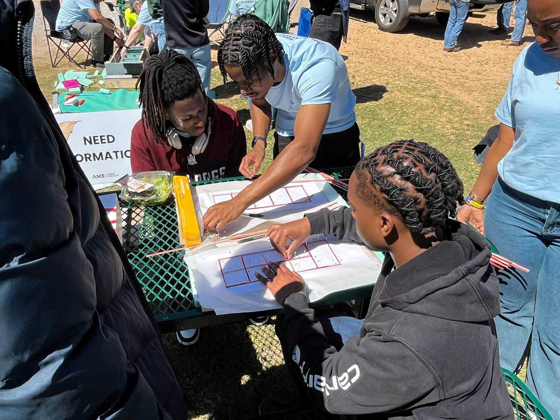 Three AAMU students work on a task at ASCE competition