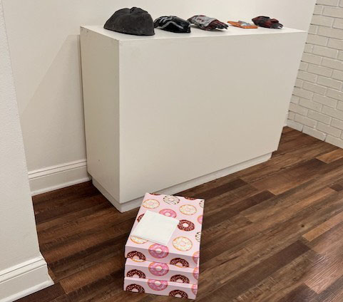 Three donut boxes on the floor of the AAMU Art Museum