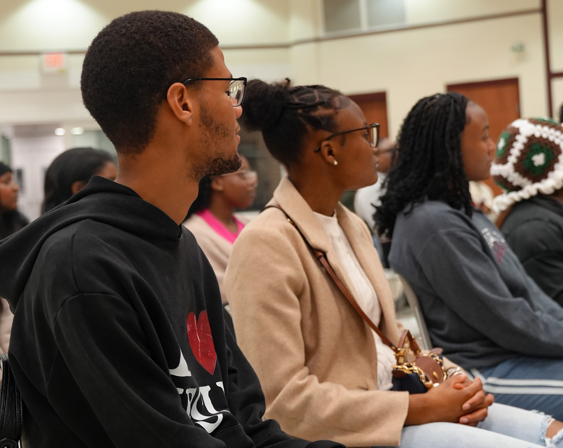 Male and two female students listen to panel on chivalry