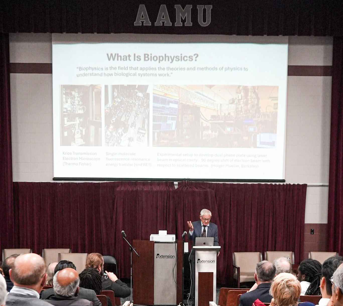Dr. Frank delivering lecture at podium in Dawson Auditorium
