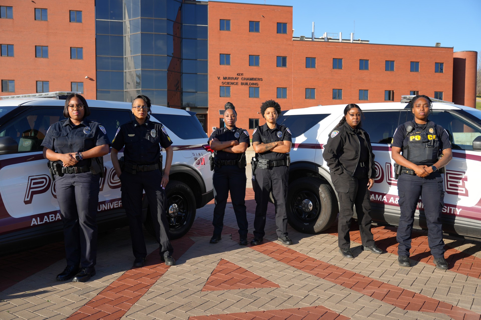 Officers pose with police cars on the AAMU Quad