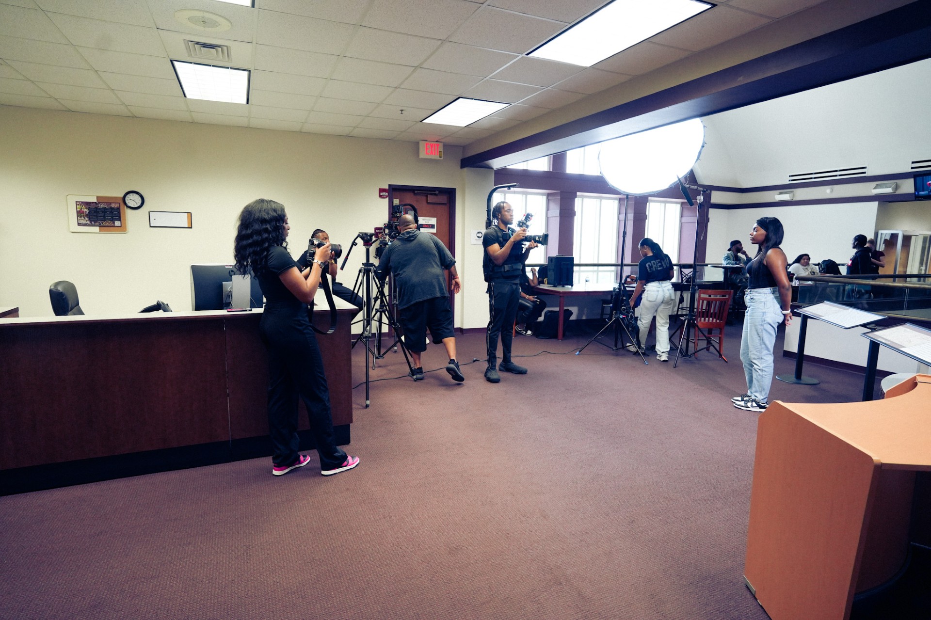 Robinson takes photos and Fletcher runs audio for student interview