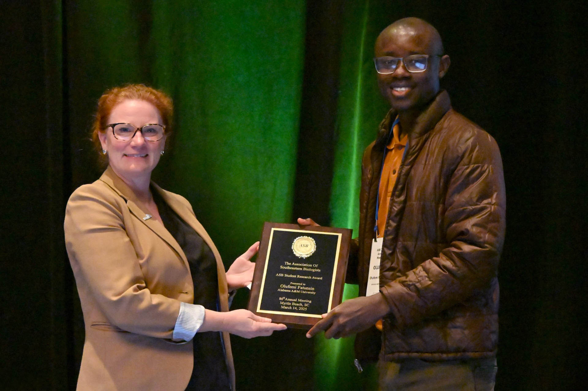 Dr. Lyndsay Rhodes with ASB Student Research Award Committee presents ASB Award to Olufemi Fatunsin