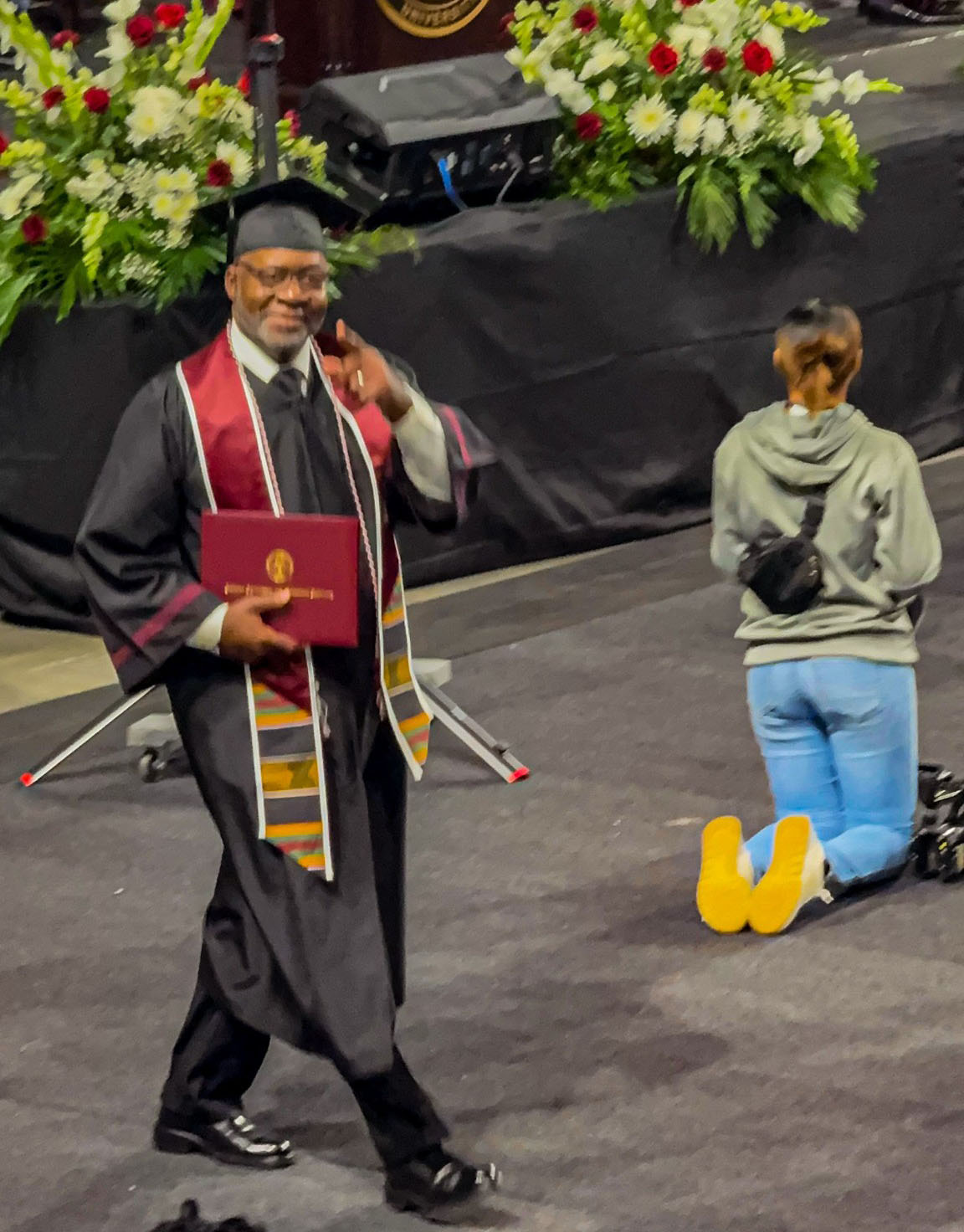 Brooks holds his diploma after crossing the stage at the AAMU Event Center
