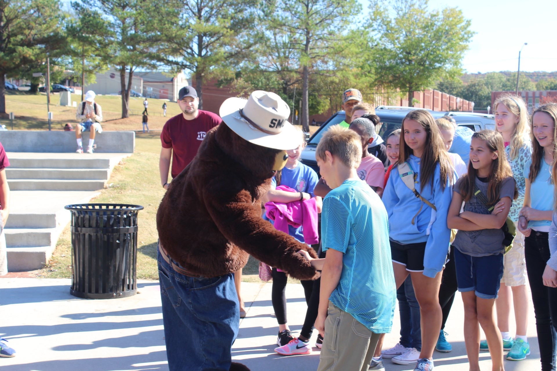Smokey the Bear talks to a group of young students