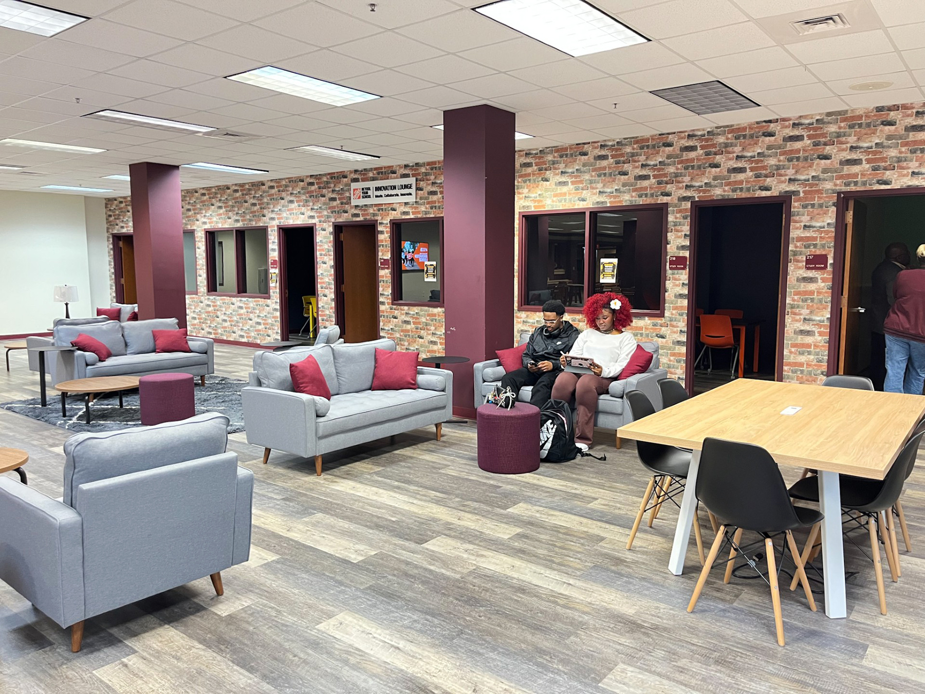 AAMU students Alex Burgess and Ariana Green sitting next to each other studying in new Student Innovation Lounge