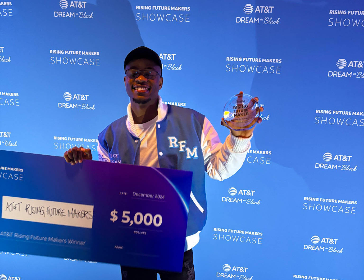 Kwenda holds his $5,000 AT&T Rising Future Makers check and trophy