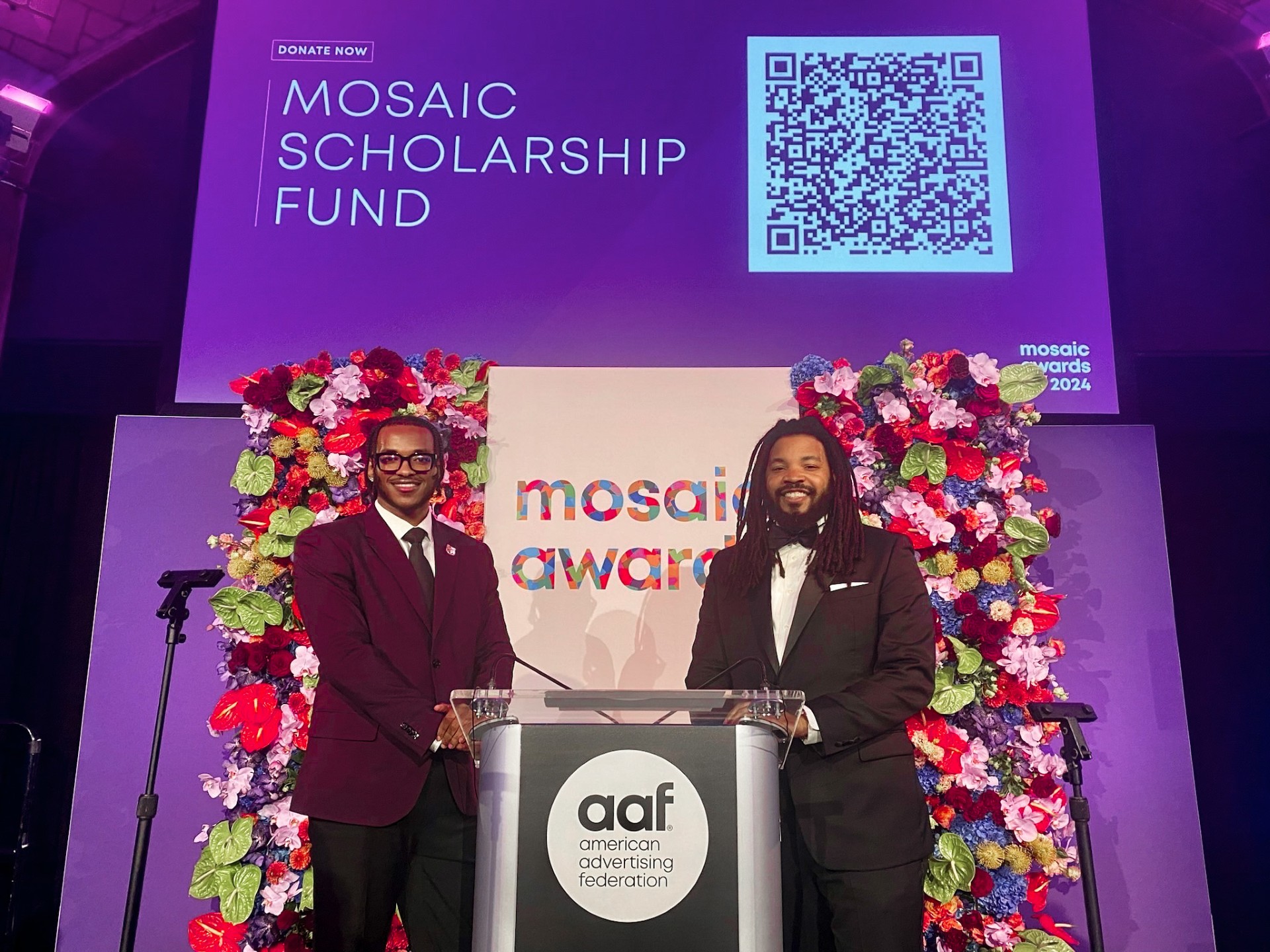 Joseph Tilaye and Craig Mitchell stand on stage at Mosaic Awards