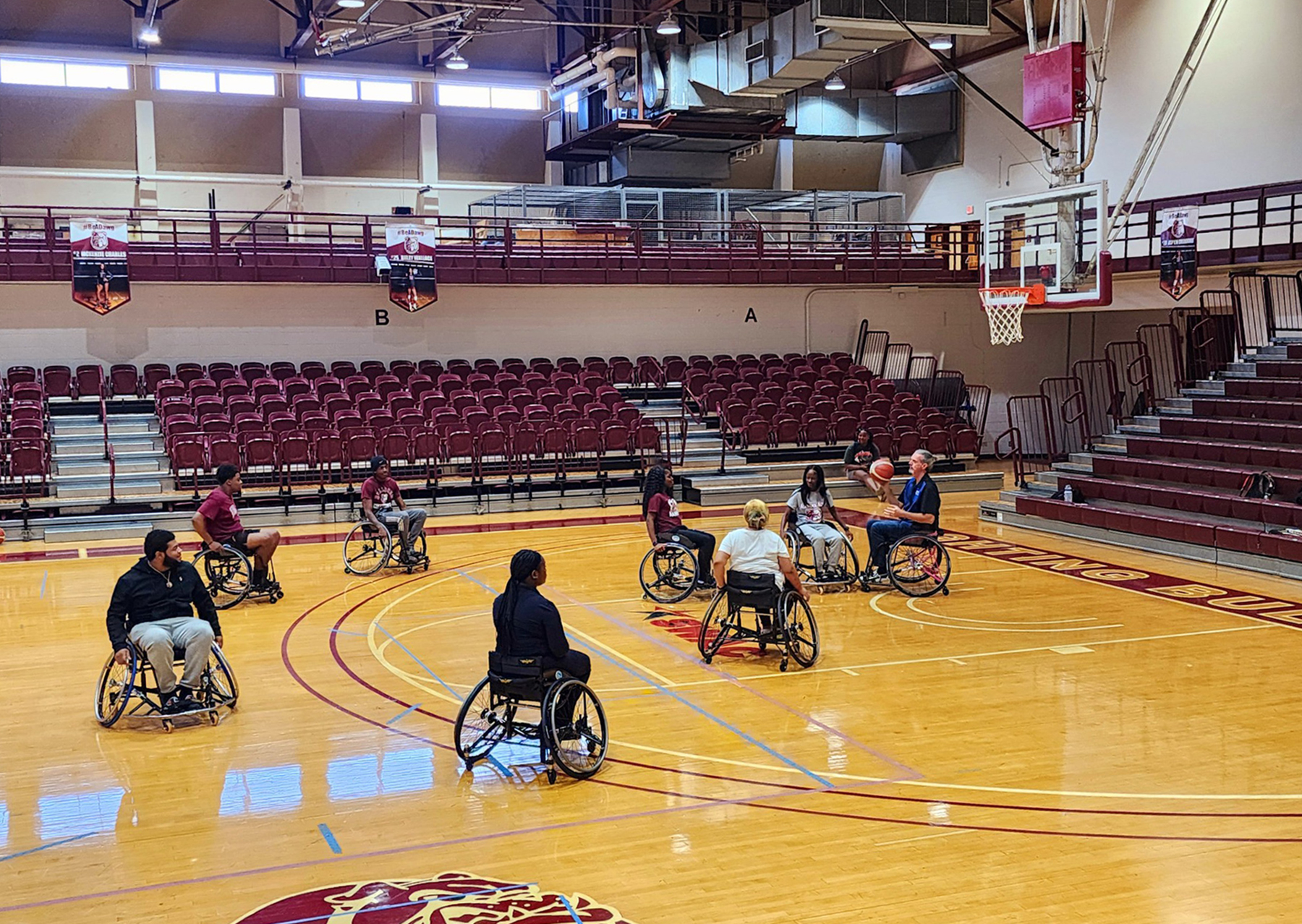 Dr. David Kyle of UAH tosses a ball to AAMU students on the court 