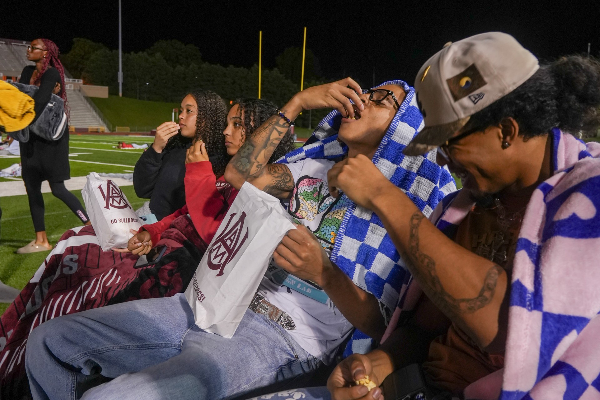 Students eating popcorn and laughing