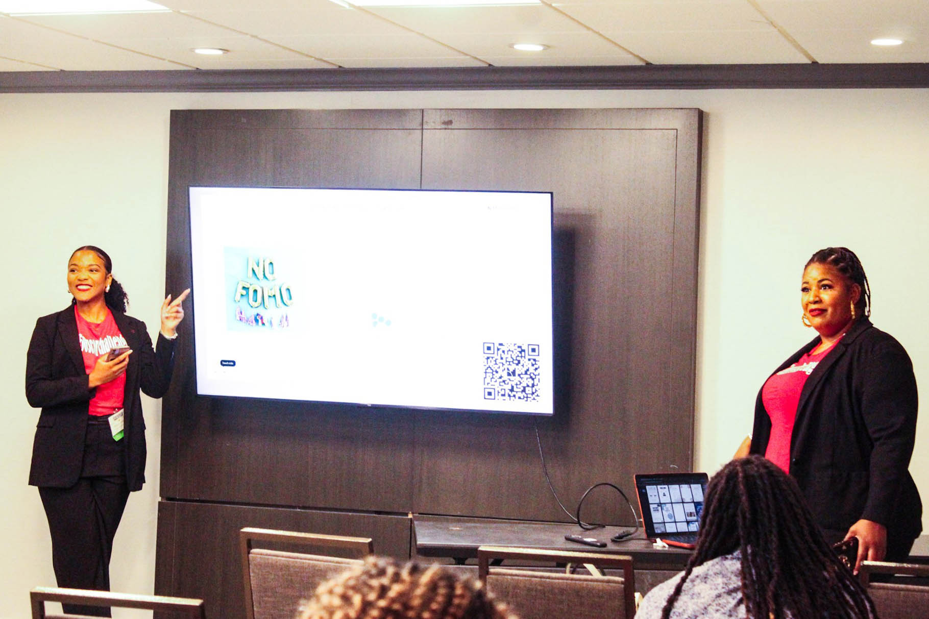 Querin points to a projector during a presentation at her summer internship with Consumers Unlimited