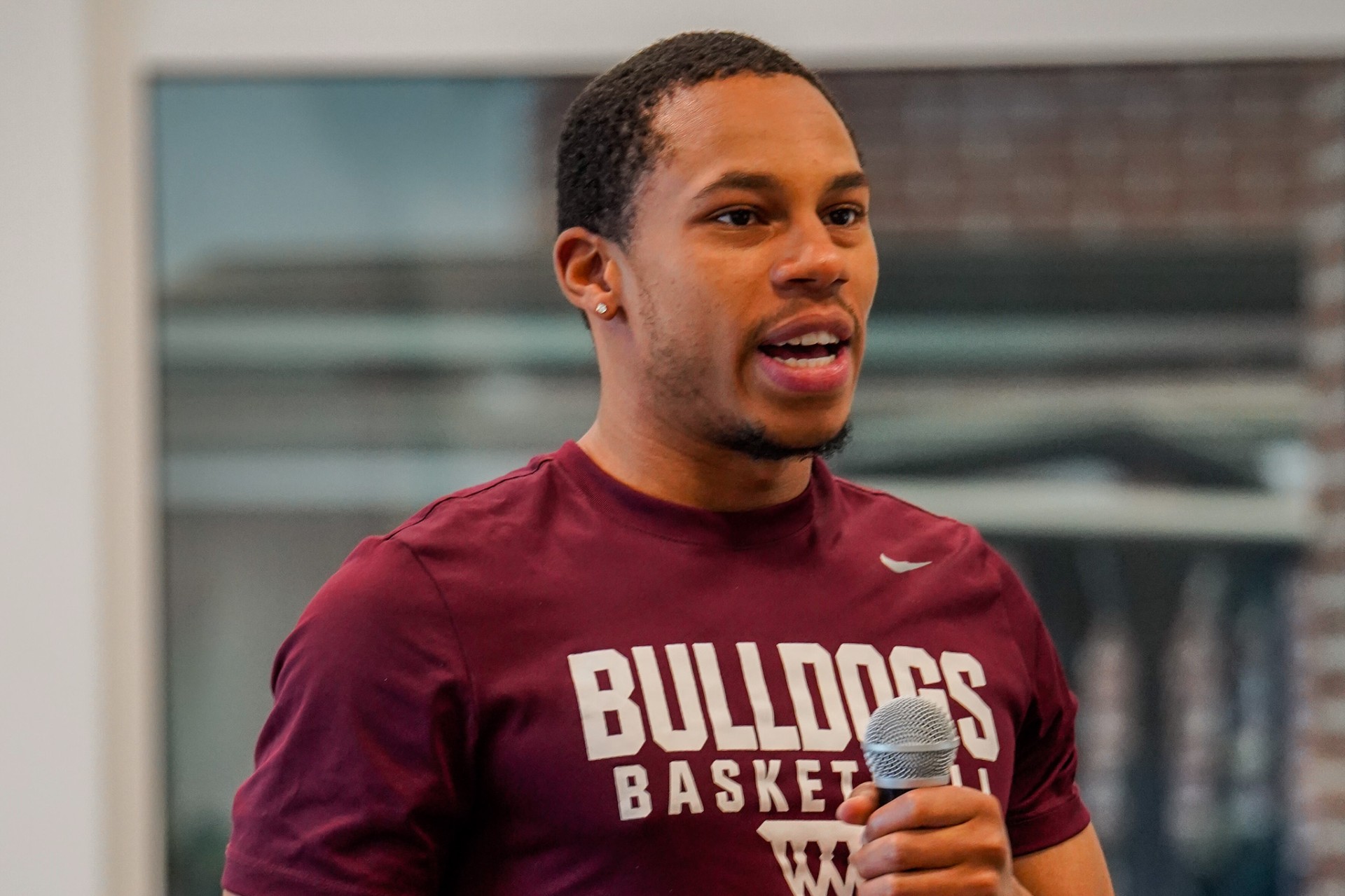 Male student holds mic and asks questions during Regions Alumni Panel Discussion