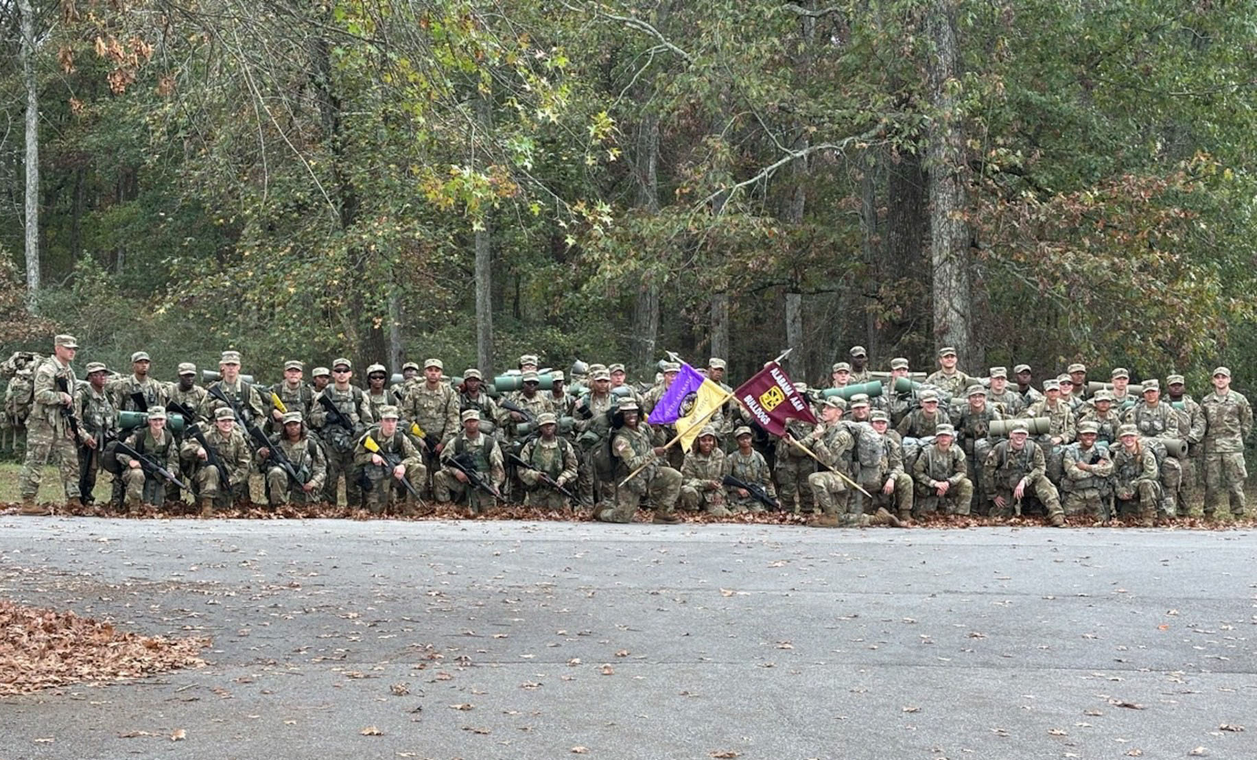Wide shot of AAMU and UNA ROTC cadets holding crossed flags from their respective battalions