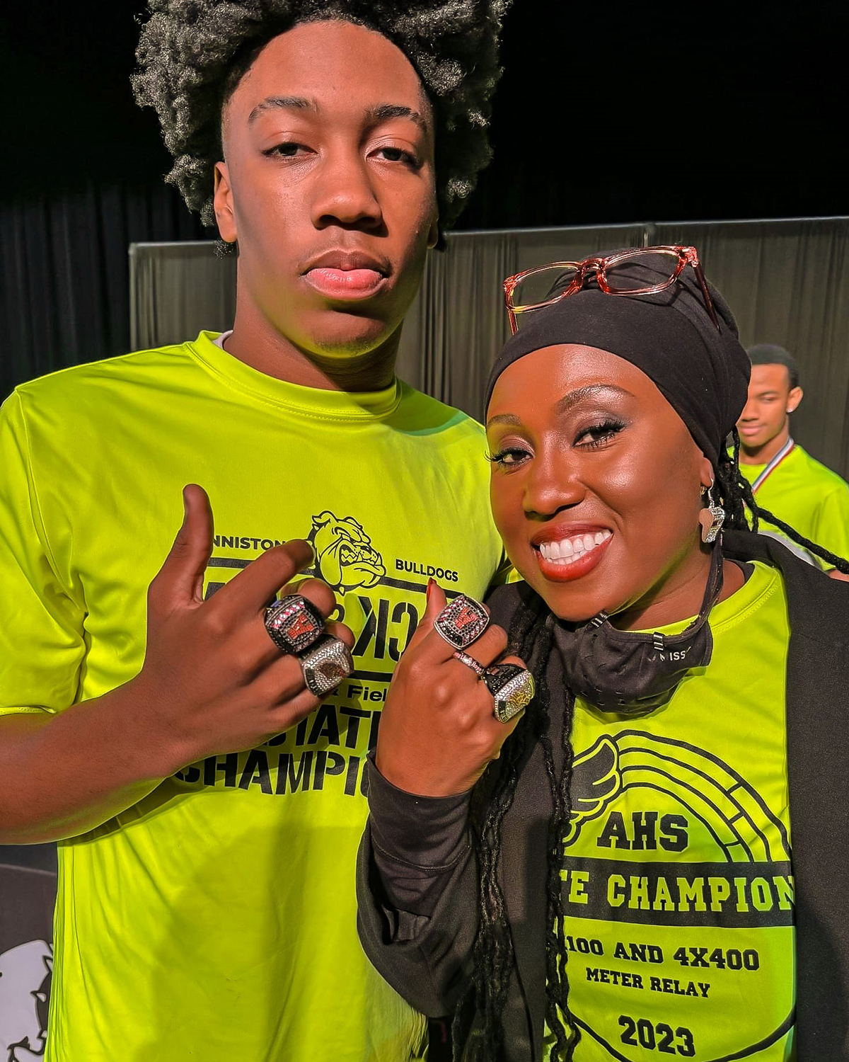 Senior Jaylen Lewis, State Champion in the 100 and 200 meter dash, and Coach Howard Holland wearing their 22-23 Championship Rings