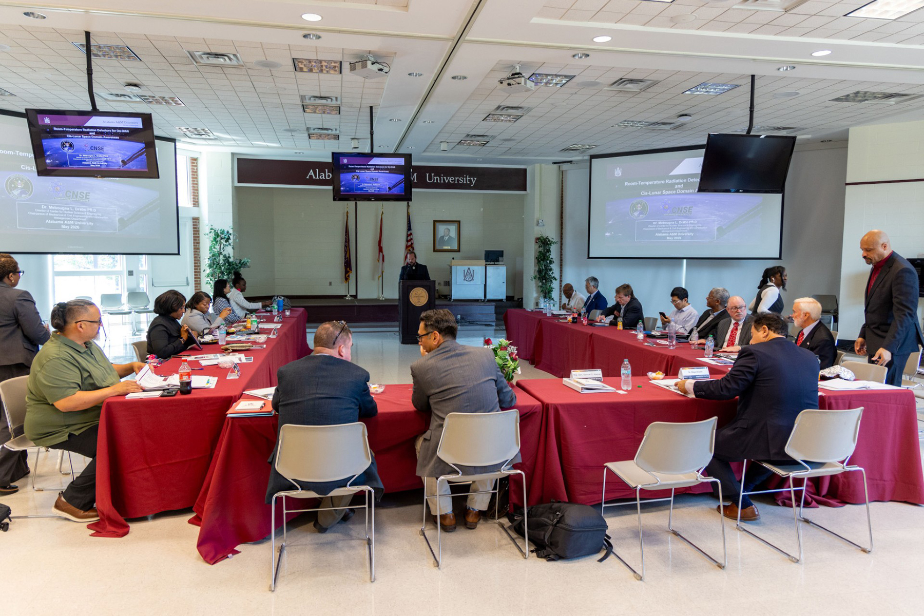 AAMU researchers and SPACECOM leaders seated around large conference table during research presentations in the AAMU Multipurpose Room