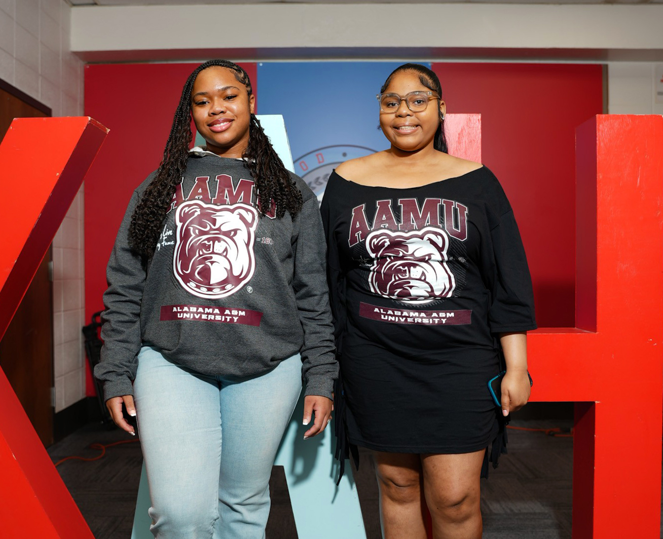 Londyn Alexander and Kyla Moore smile in the King Room at Kenwood Academy High School in Chicago