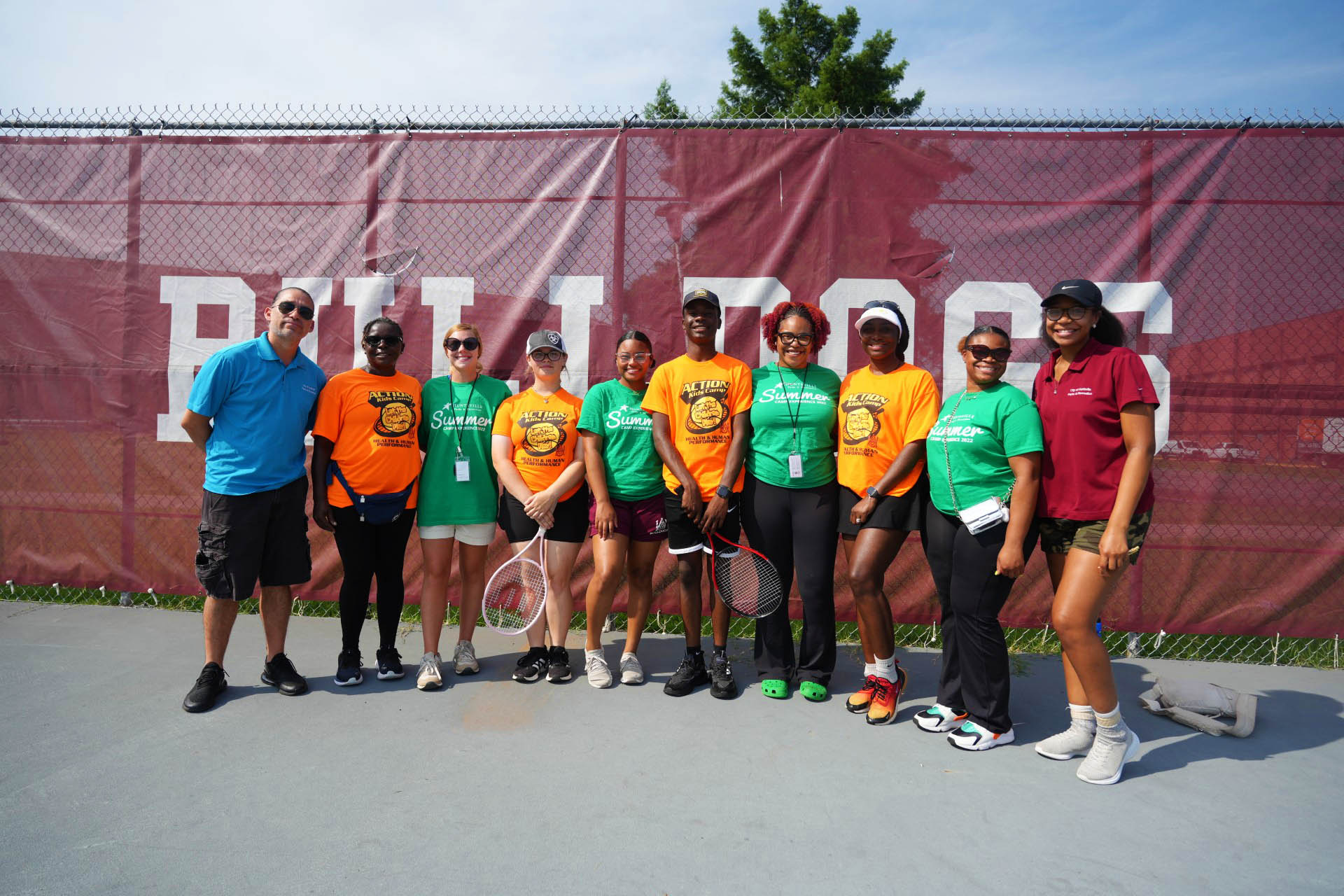 Dr. M'mbaha-Zarnesky with tennis camp volunteers at AAMU Tennis Court