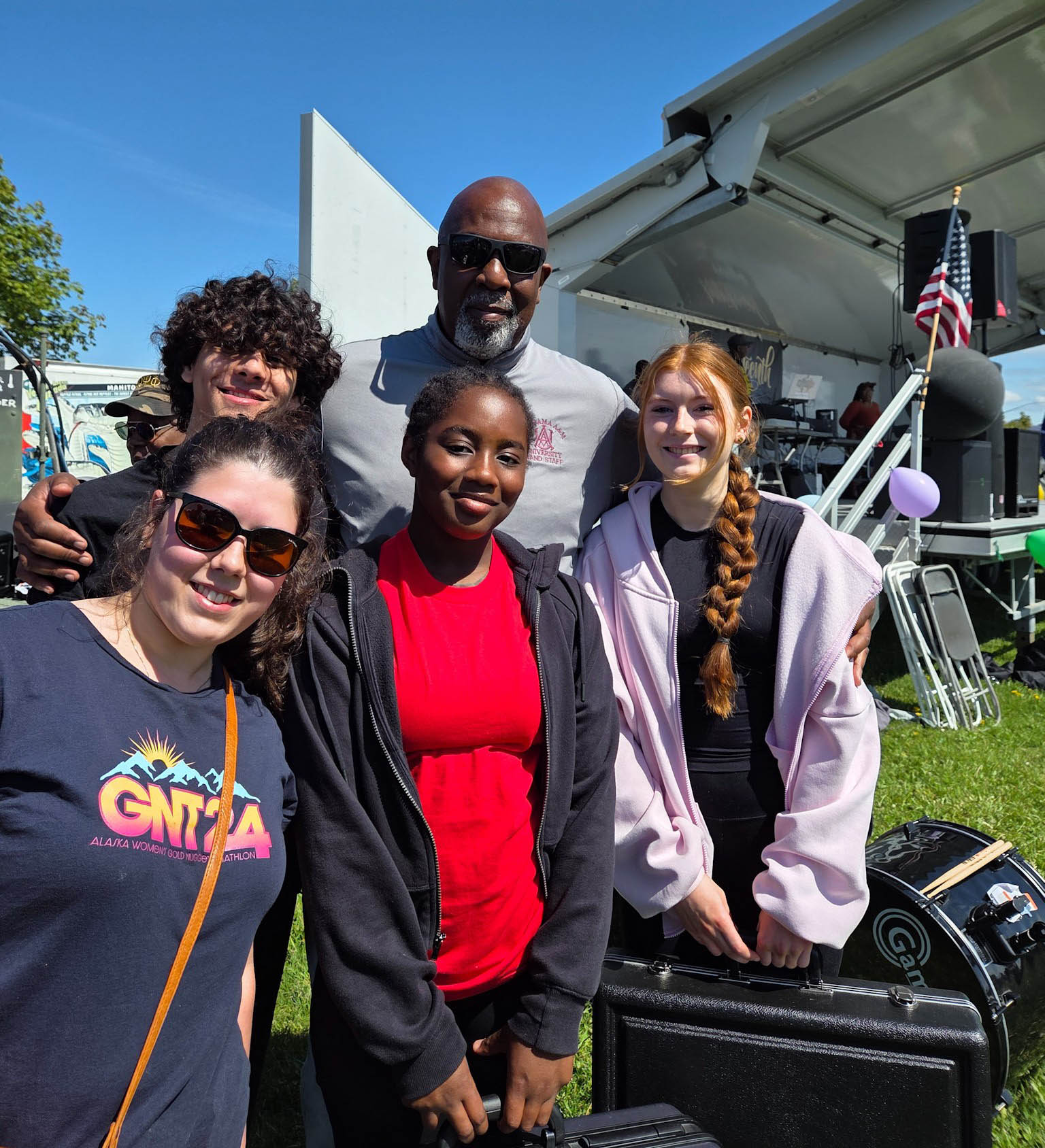 Wright outside with three female students and one male student in HBCU Band Camp