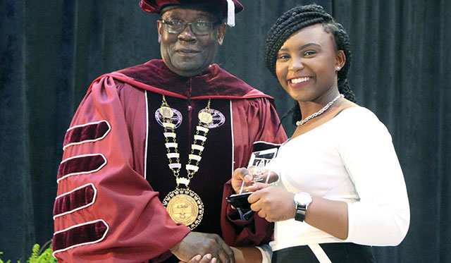 A honors student receives an award from the President of AAMU during the Honors Convocation