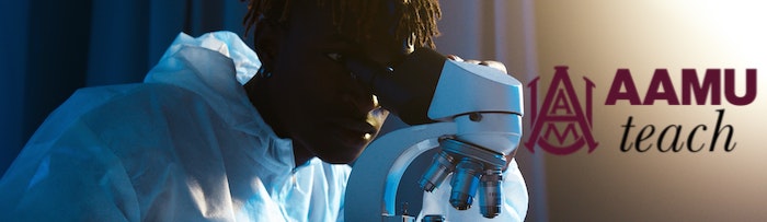 AAMU student looking into microscope