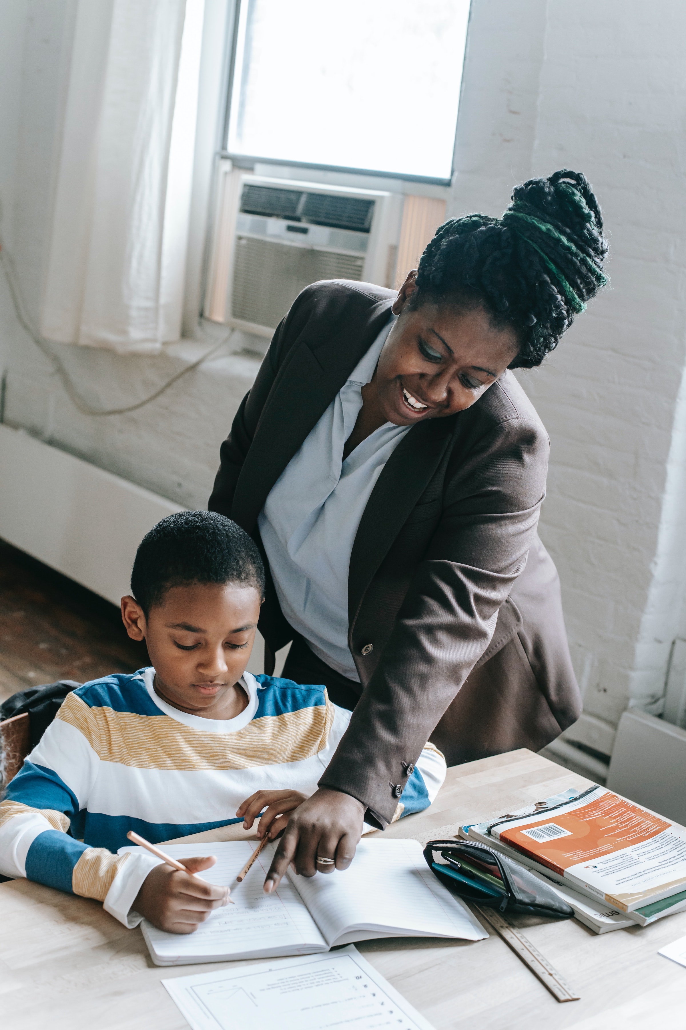 Black woman teaching a child