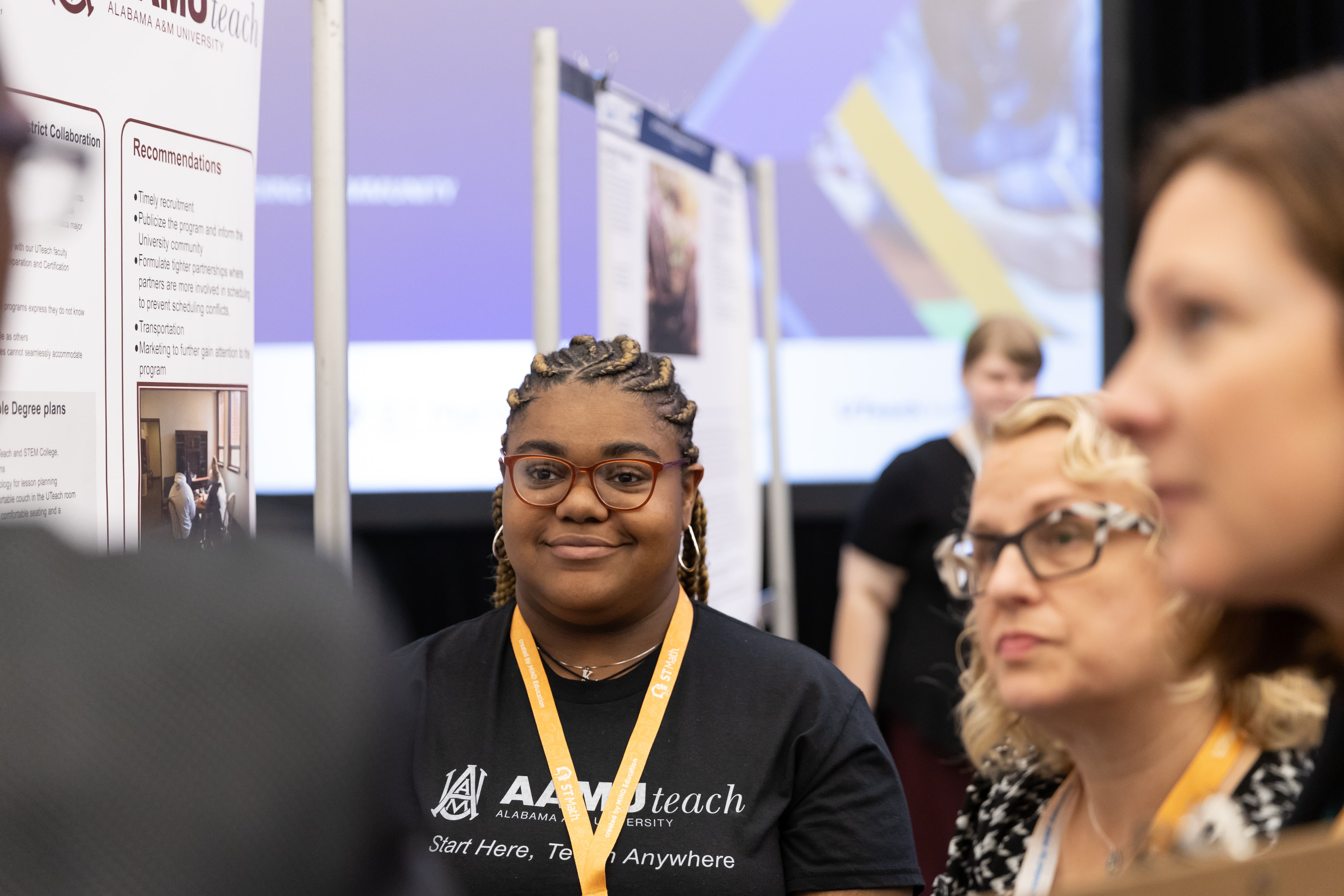 a student presenting poster in the conference