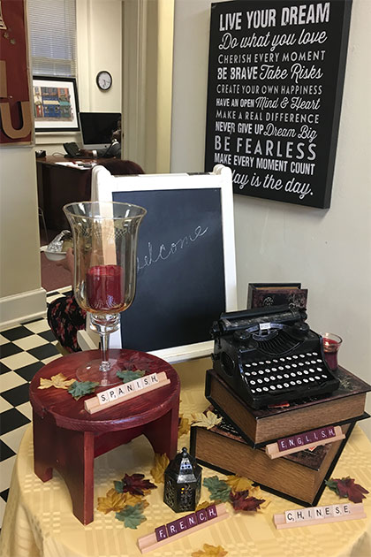 Decorative display for English and Foreign Languages open house event. Scrabble trays spell out the words "English", "Spanish", "French", and "Chinese". A blackboard behind the display says "Welcome".