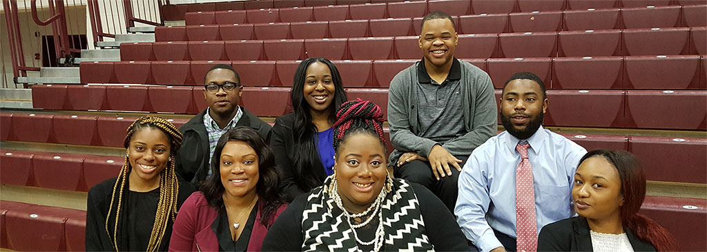 Smiling undergraduate social work students at an event