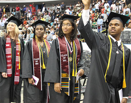 Smiling students in line at Commencement