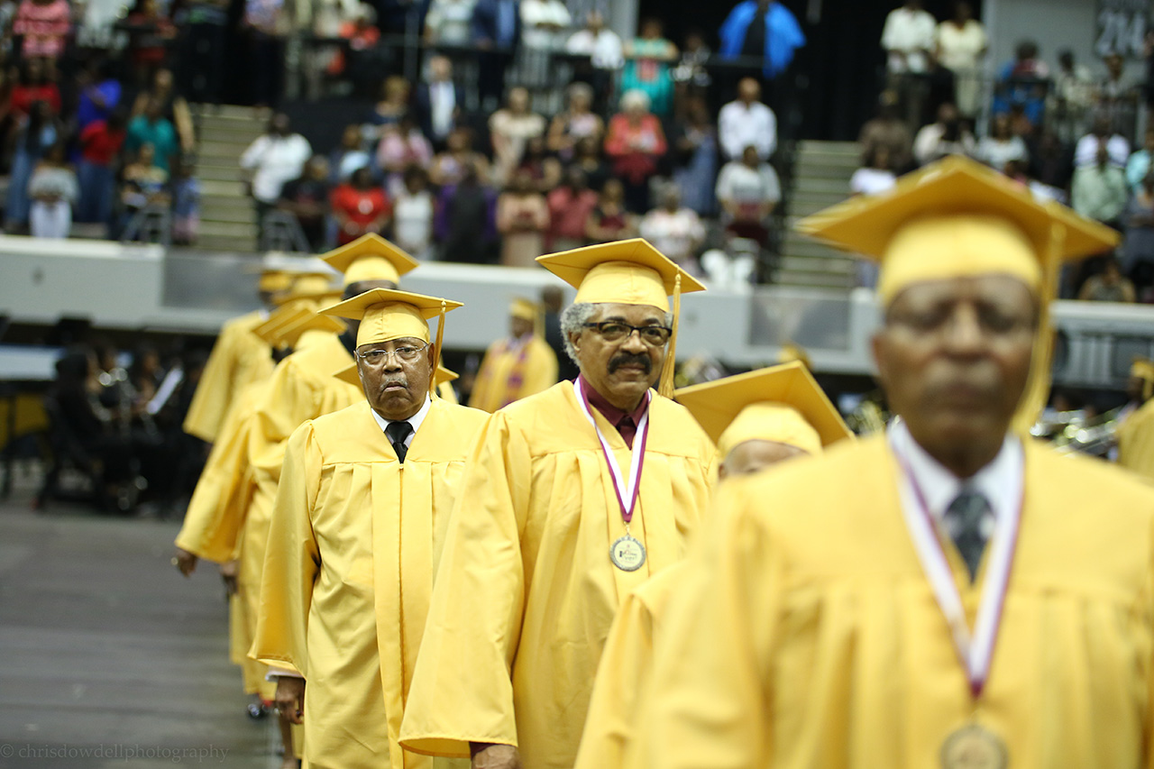 A photo of the golden class walking into commencement.